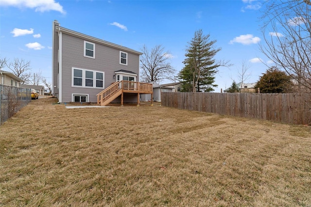 rear view of property with a wooden deck and a yard