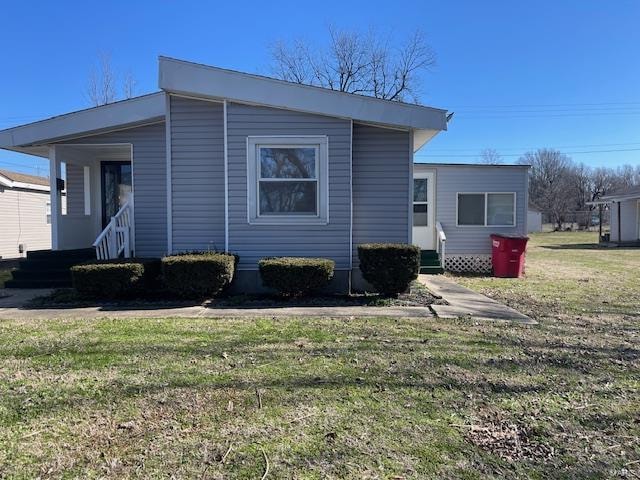 view of side of home featuring a lawn