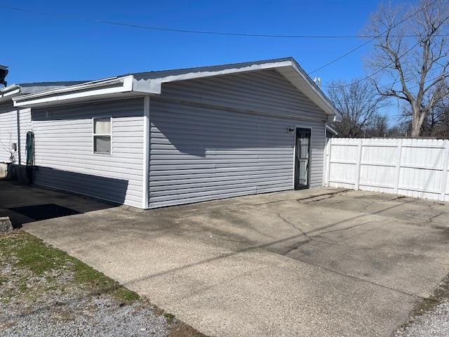 view of side of property with a patio area