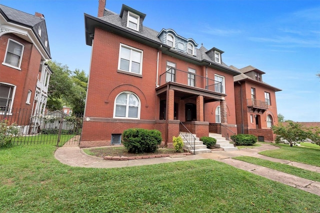 view of front of home with a balcony and a front yard