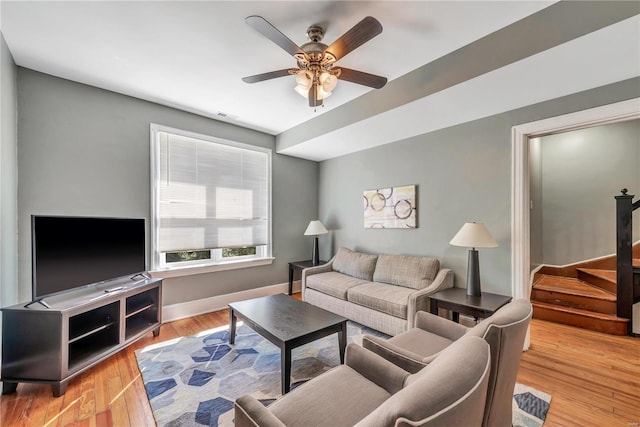 living room featuring light hardwood / wood-style floors and ceiling fan