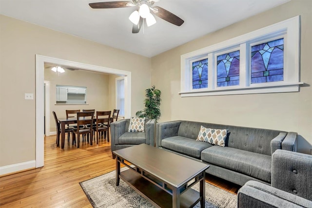 living room with ceiling fan and light wood-type flooring