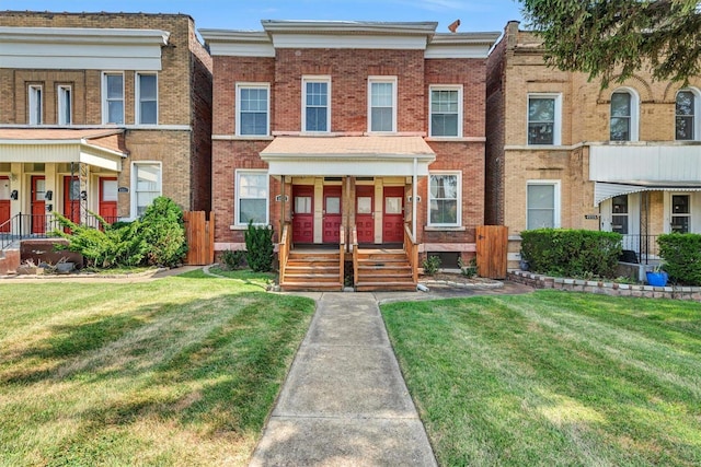 multi unit property featuring a porch and a front yard