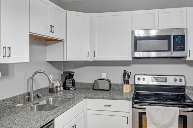 kitchen with white cabinetry, sink, stainless steel appliances, and light stone countertops