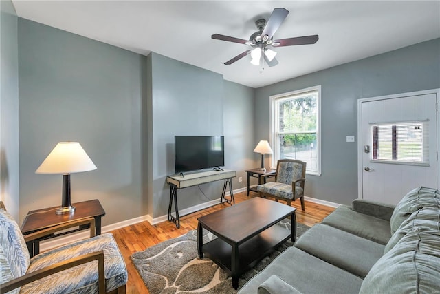 living room featuring ceiling fan, a wealth of natural light, and light wood-type flooring