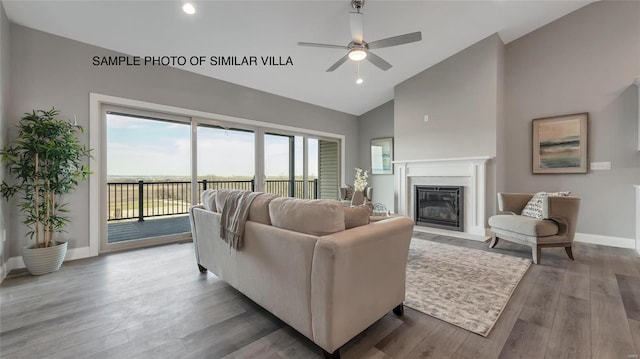 living room with ceiling fan, hardwood / wood-style floors, and high vaulted ceiling