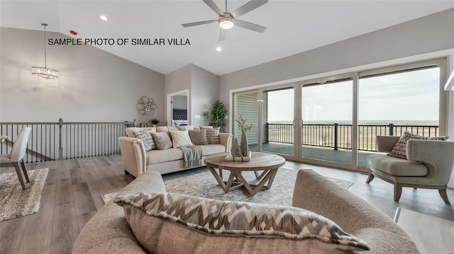 living room with plenty of natural light, ceiling fan, vaulted ceiling, and light hardwood / wood-style flooring