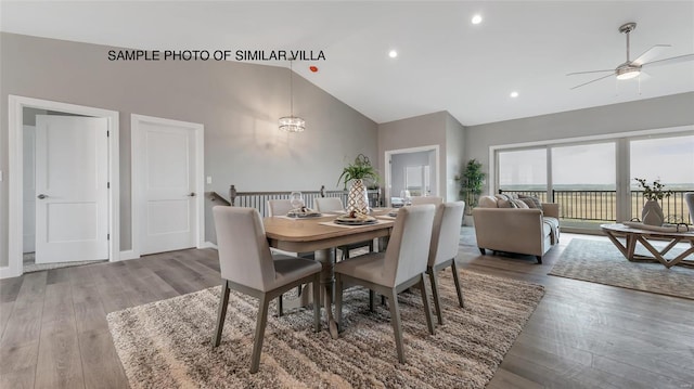 dining space with ceiling fan, high vaulted ceiling, and dark wood-type flooring