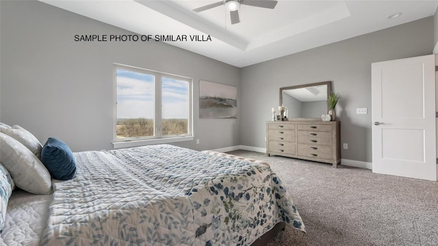 bedroom featuring ceiling fan, light colored carpet, and a tray ceiling