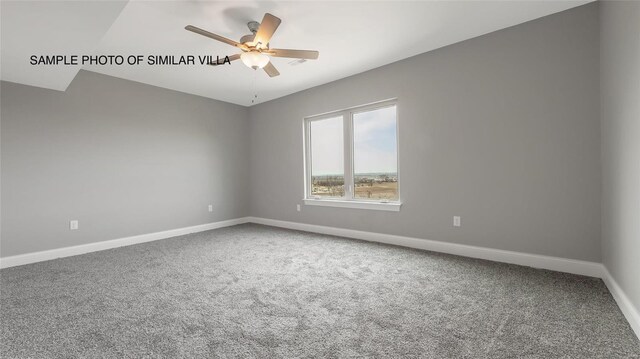 carpeted empty room featuring ceiling fan and lofted ceiling