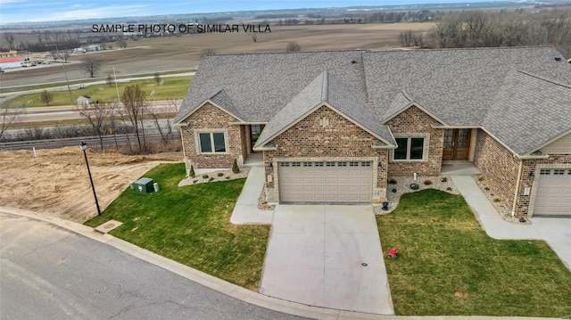 view of front of home featuring a front yard and a garage