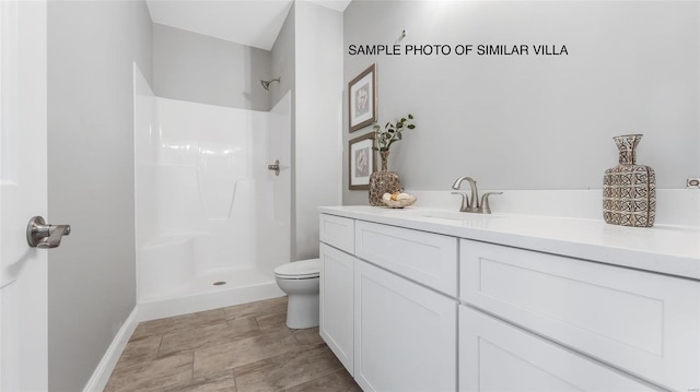 bathroom featuring toilet, tile flooring, walk in shower, and vanity