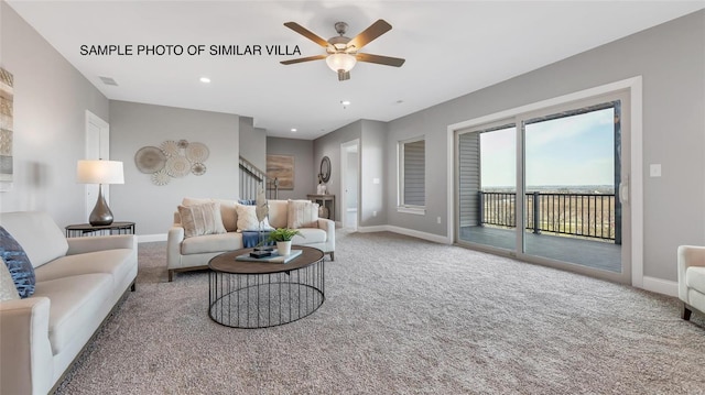 carpeted living room with ceiling fan