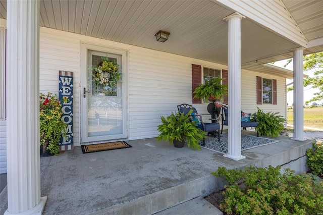 view of exterior entry featuring a porch