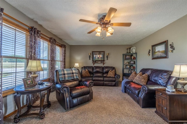 living room with light carpet, a textured ceiling, and ceiling fan