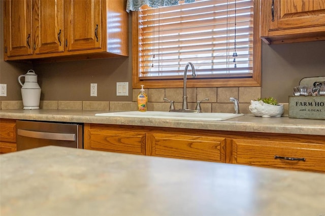 kitchen with plenty of natural light, backsplash, dishwasher, and sink