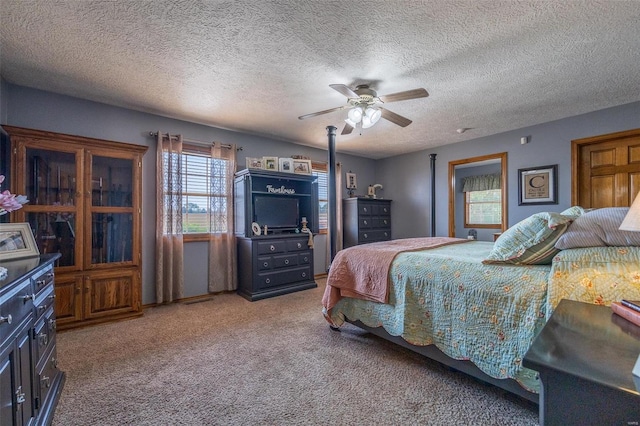 bedroom featuring ceiling fan, a textured ceiling, and carpet floors