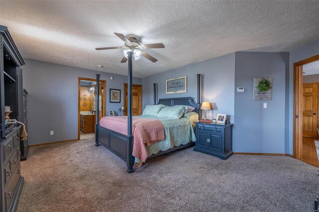 bedroom featuring a textured ceiling, ensuite bath, ceiling fan, and carpet floors