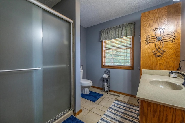 bathroom with a textured ceiling, tile flooring, toilet, and vanity