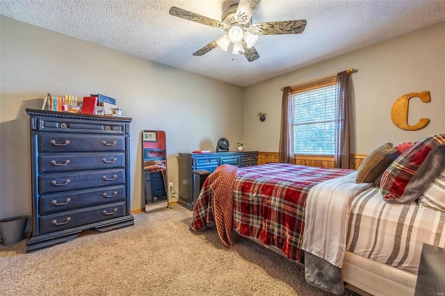 carpeted bedroom with a textured ceiling and ceiling fan