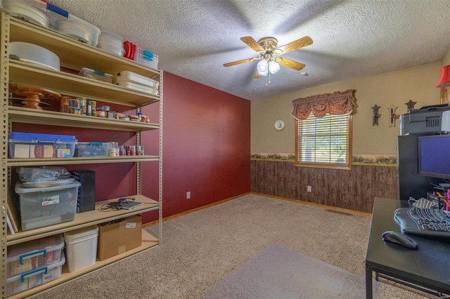 interior space with ceiling fan, a textured ceiling, and carpet flooring