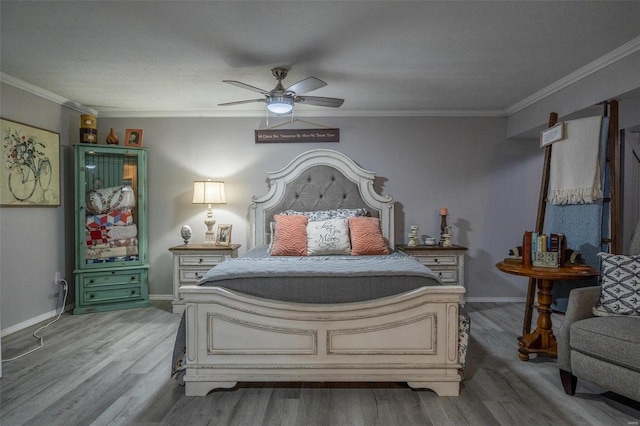 bedroom featuring ceiling fan, light wood-type flooring, and crown molding