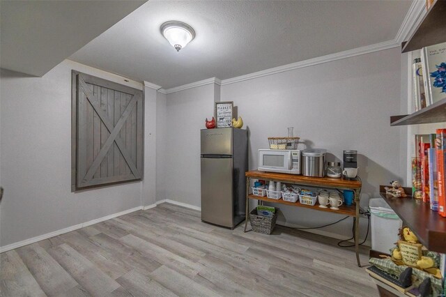 misc room with crown molding and light hardwood / wood-style flooring