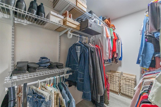 walk in closet with light wood-type flooring