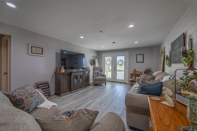 living room with light wood-type flooring and french doors