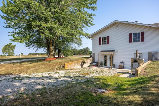 back of property with a lawn