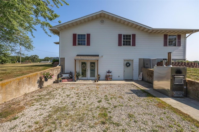 back of property featuring a patio, central air condition unit, and french doors