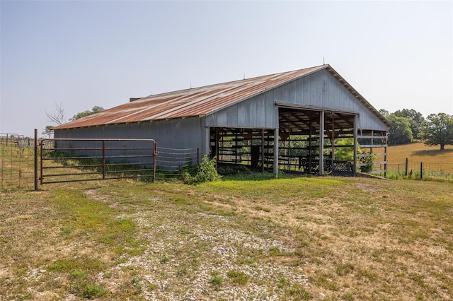 view of outdoor structure featuring a rural view and a yard