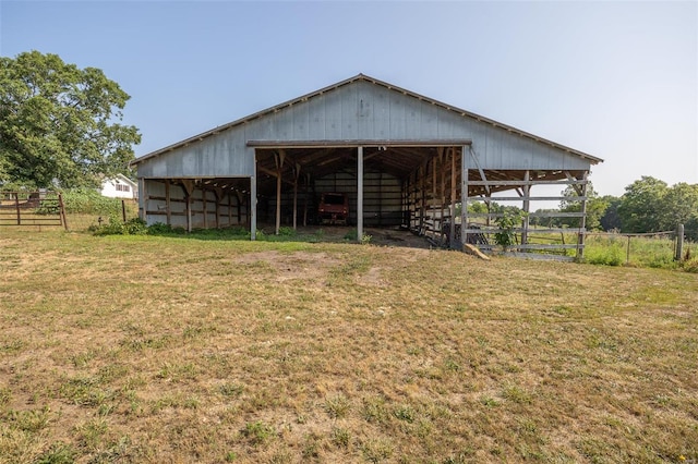 rear view of property featuring a lawn and an outdoor structure