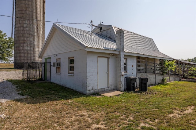 back of property featuring a yard