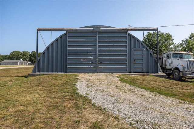 view of gate with a yard