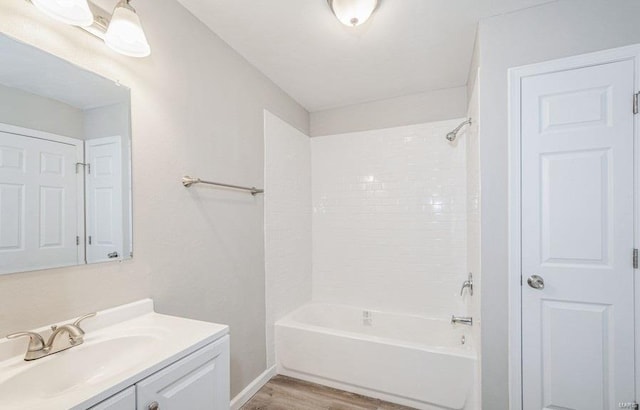 bathroom featuring bathtub / shower combination, hardwood / wood-style flooring, and oversized vanity