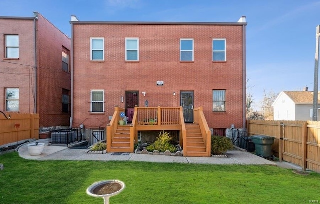 rear view of house featuring a yard and a patio area