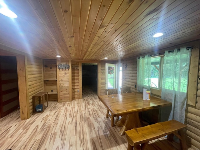 dining space with wooden walls, wood ceiling, log walls, and light hardwood / wood-style flooring