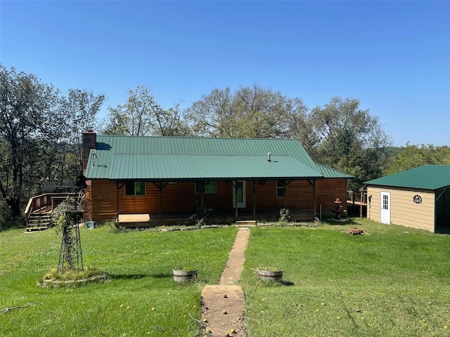 back of property featuring a lawn