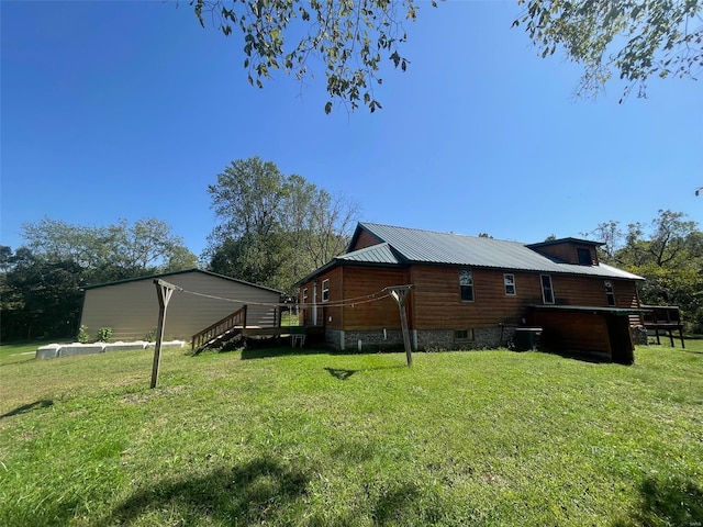 back of property featuring a deck and a yard