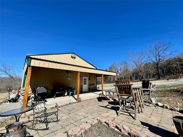 exterior space with ceiling fan