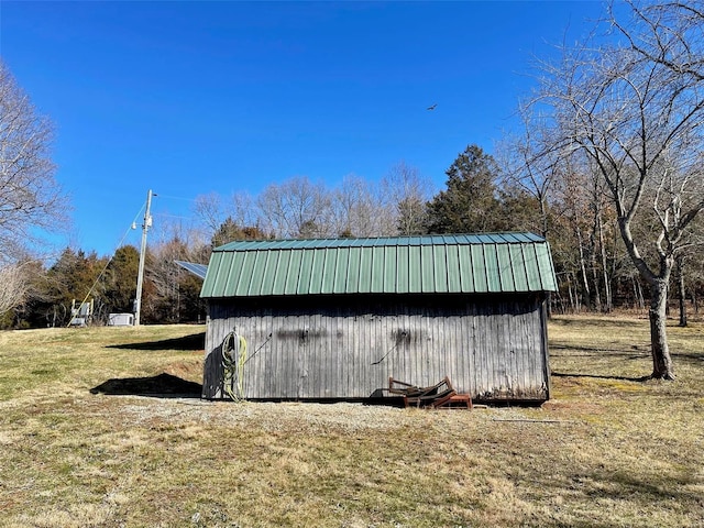 view of outdoor structure featuring a lawn