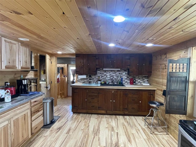 kitchen with sink, wooden walls, wooden ceiling, light hardwood / wood-style floors, and decorative backsplash