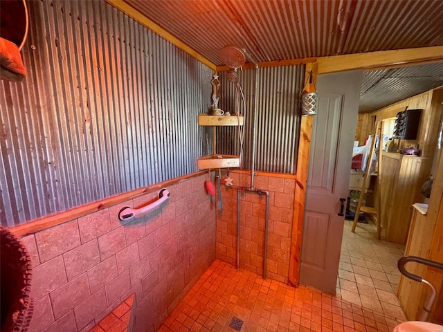 bathroom with tile walls and tile patterned flooring