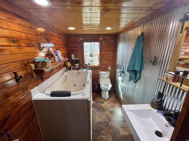 bathroom with a bath, wood ceiling, wooden walls, and toilet