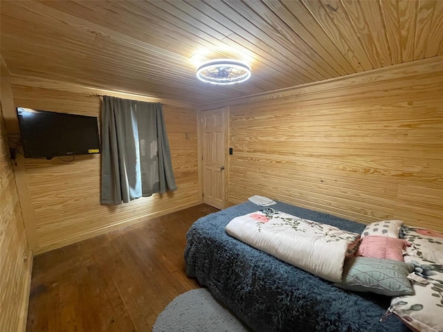 bedroom with wood ceiling, wood walls, and hardwood / wood-style floors