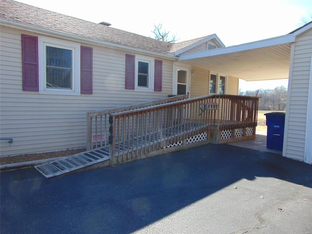 view of property exterior featuring a wooden deck