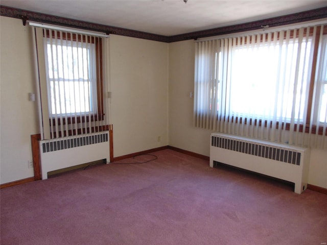 carpeted empty room with radiator