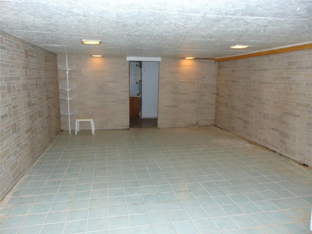 basement with brick wall and light tile flooring