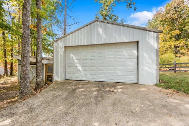 detached garage featuring fence